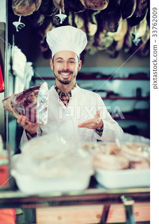 Seller offering piece of meat Seller offering piece of meat 33762009