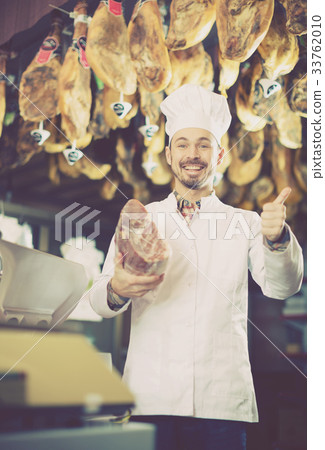 Seller offering piece of meat Seller offering piece of meat 33762010