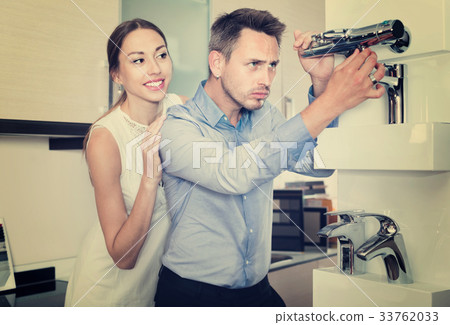 Family couple looking for modern functional mixer tap 33762033
