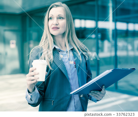 Professional woman in jacket with coffee 33762323