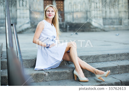 portrait of woman sitting on steps portrait of woman sitting on steps 33762613