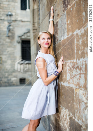 female standing near the stone wall female standing near the stone wall 33762651