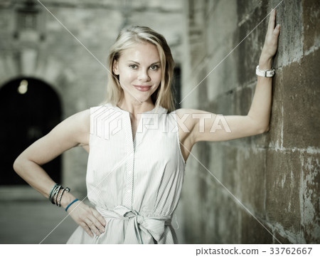 female standing near the stone wall 33762667