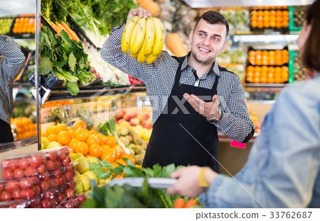 Male seller assisting in buying 33762687