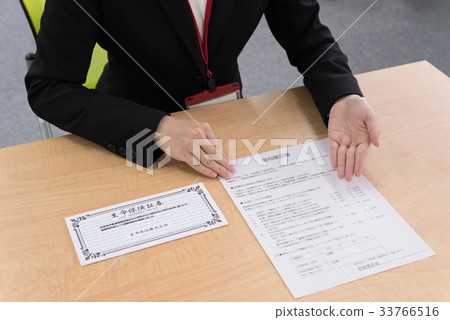 Female employee explaining intention confirmation at counter Female employee explaining intention confirmation at counter 33766516