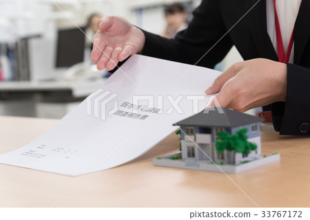 Female employee explaining existing housing survey report at counter 33767172