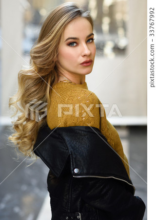 Beautiful blonde russian woman in urban background Beautiful blonde russian woman in urban background 33767992