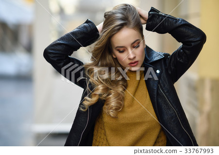 Beautiful blonde russian woman in urban background Beautiful blonde russian woman in urban background 33767993
