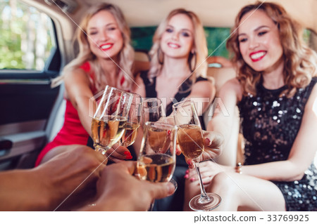 Pretty women having party in a limousine car and Pretty women having party in a limousine car and 33769925