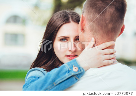 Young couple in love hug each other in city 33773077