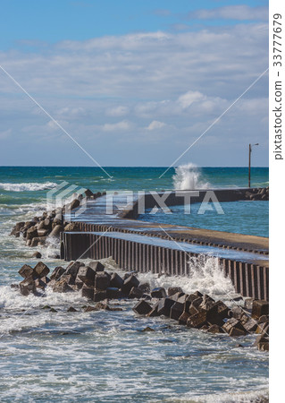 Waves to strike the breakwater Waves to strike the breakwater 33777679