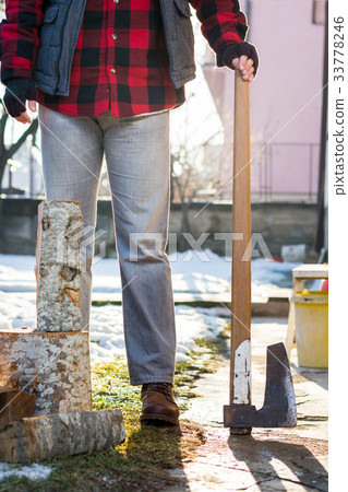 Masculine man with an axe for cutting firewood 33778246