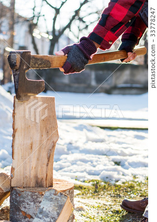 Man cutting firewood for the winter 33778247