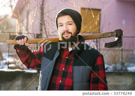 Masculine man with an axe for cutting firewood Masculine man with an axe for cutting firewood 33778249