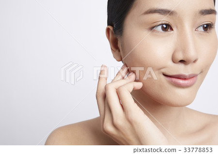 A young woman is smiling on a white background 33778853