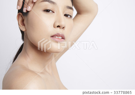 a young woman is posing with her hand on head 33778865