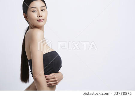 A beautiful girl is posing in a white background 33778875