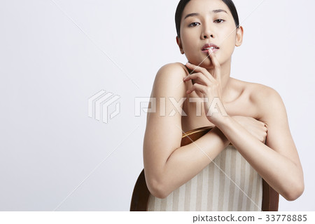 portrait of an Asian woman sitting and posing on a chair 33778885