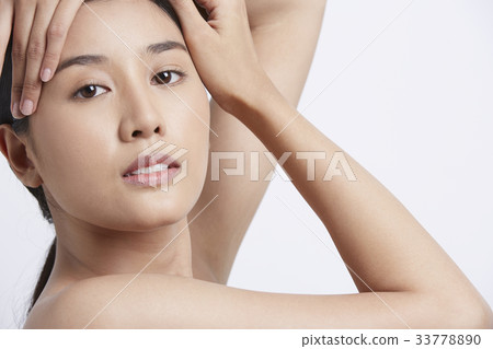 A beautiful model is posing and looking at camera 33778890