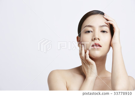 an attractive girl is putting her hand on her face an attractive girl is putting her hand on her face 33778910