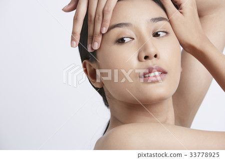 a girl is putting hands on her head and looking at something a girl is putting hands on her head and looking at something 33778925