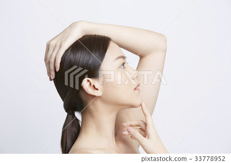 a girl is putting hand on her head and looking at something 33778952