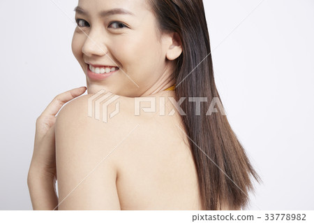 young woman is looking over her shoulder with happiness young woman is looking over her shoulder with happiness 33778982