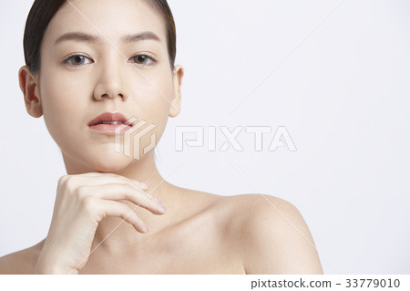 photo of beautiful young woman with black hair and hand on chin 33779010