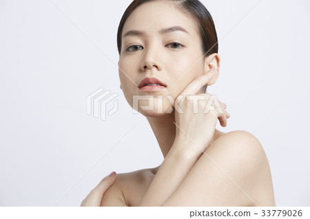 young woman with fresh clean skin is touching her face young woman with fresh clean skin is touching her face 33779026