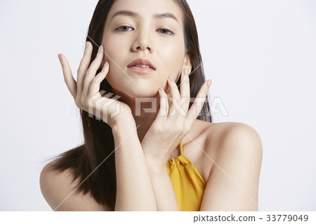 portrait of attractive woman touching her face 33779049