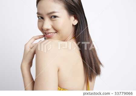 side view portrait of young woman looking at camera and smiling side view portrait of young woman looking at camera and smiling 33779066