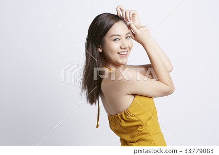 portrait of a woman touching her head and smiling inside 33779083