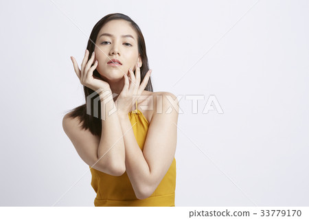 A Thai girl is posing photo with her hands on white background 33779170