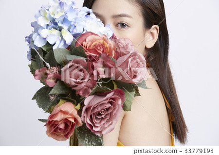 portrait of a girl hiding after flowers portrait of a girl hiding after flowers 33779193