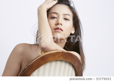 portrait of girl touching her hair and posing 33779201