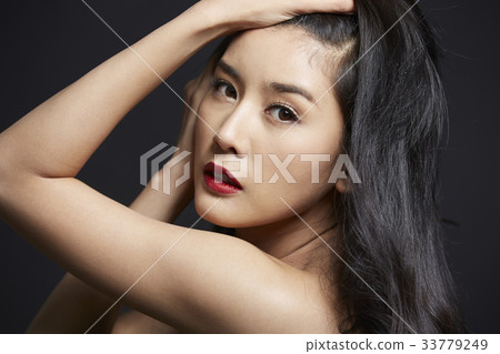 An elegant woman is showing off her beauty in the studio. 33779249