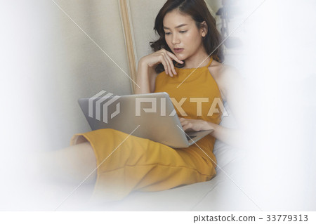 photo of a woman concentrating on work with a laptop. photo of a woman concentrating on work with a laptop. 33779313