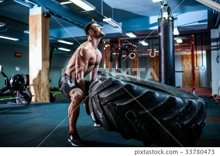 crossfit training - man flipping tire crossfit training - man flipping tire 33780473