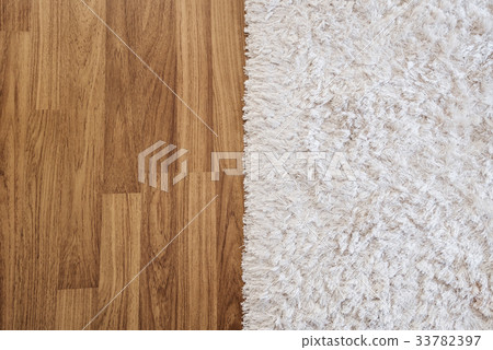 Close-up white carpet on laminate wood floor Close-up white carpet on laminate wood floor 33782397