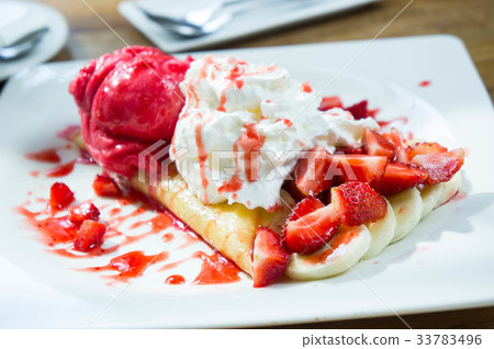 ice cream strawberry crepe dessert on white dish 33783496