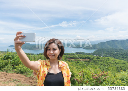 Female traveler selfie with her smart phone 33784883