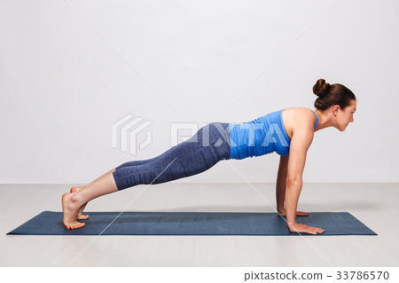 Woman doing yoga Surya Namaskar Sun Salutation Woman doing yoga Surya Namaskar Sun Salutation 33786570