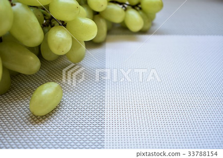 Ripe grapes on the grey tablecloth, copy space. Ripe grapes on the grey tablecloth, copy space. 33788154