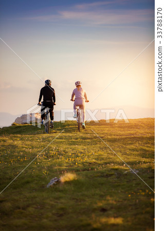 Happy mountainbike couple outdoors have fun Happy mountainbike couple outdoors have fun 33788170