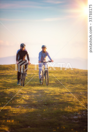 Happy mountainbike couple outdoors have fun Happy mountainbike couple outdoors have fun 33788175