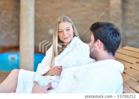 Beautiful couple relaxing together at spa centre 33788252
