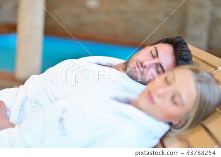 Beautiful couple relaxing together at spa centre Beautiful couple relaxing together at spa centre 33788254