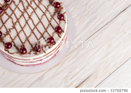 Chocolate cake with mousse, decorated cherries 33788796