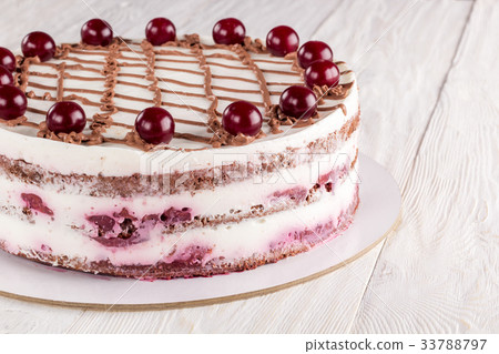 Chocolate cake with mousse, decorated cherries 33788797