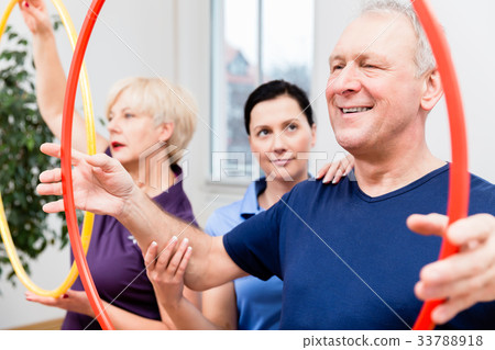Senior couple in physiotherapy doing exercise with 33788918